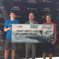 Jamie Cleghorn & Max Armstrong handing a large cheque to the Canadian Diabetes Association